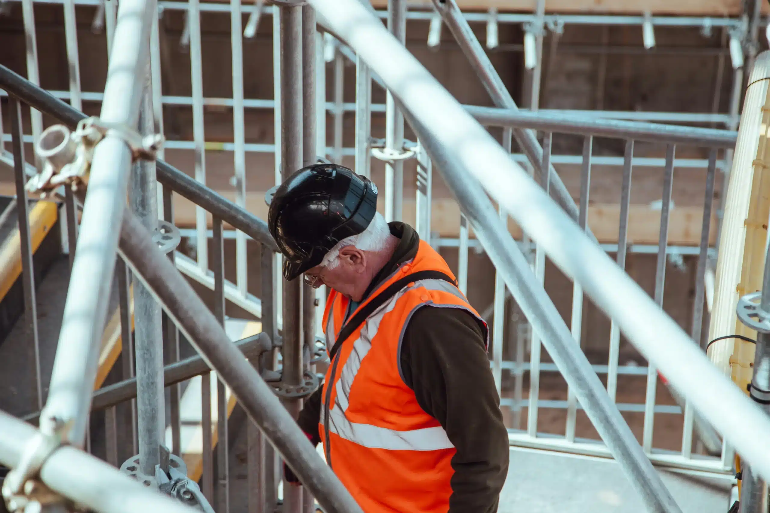 engineer in high visibility attire walking upstairs